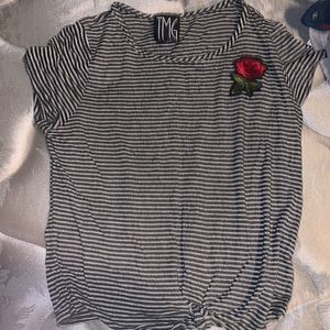 A white and black striped shirt with a rose